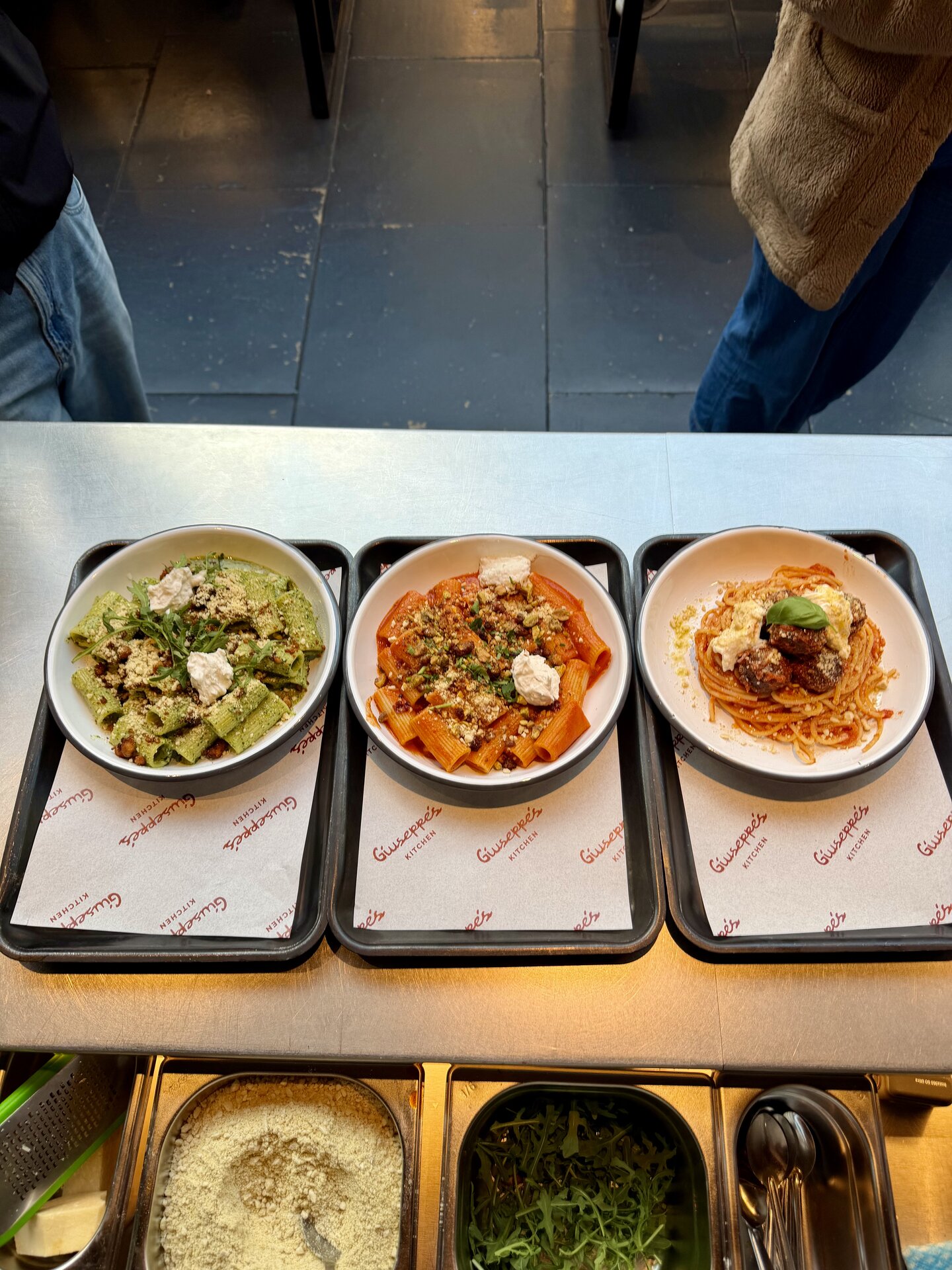 A bowl of plant-based rigatoni in vibrant red sauce